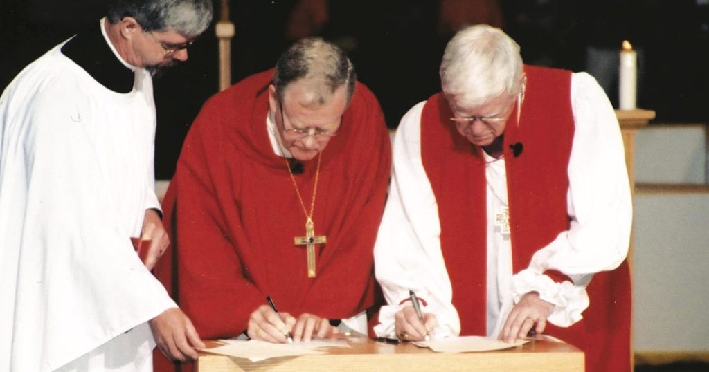 Telmor Sartison, then-national bishop of the Evangelical Lutheran Church in Canada, and Archbishop Michael Peers, then-primate of the Anglican Church of Canada, sign the Waterloo Declaration in 2001.